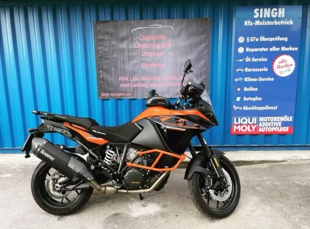 KTM 1290 Super Adventure vor dem Werkstatt-Banner des KFZ-Meisterbetriebs Singh